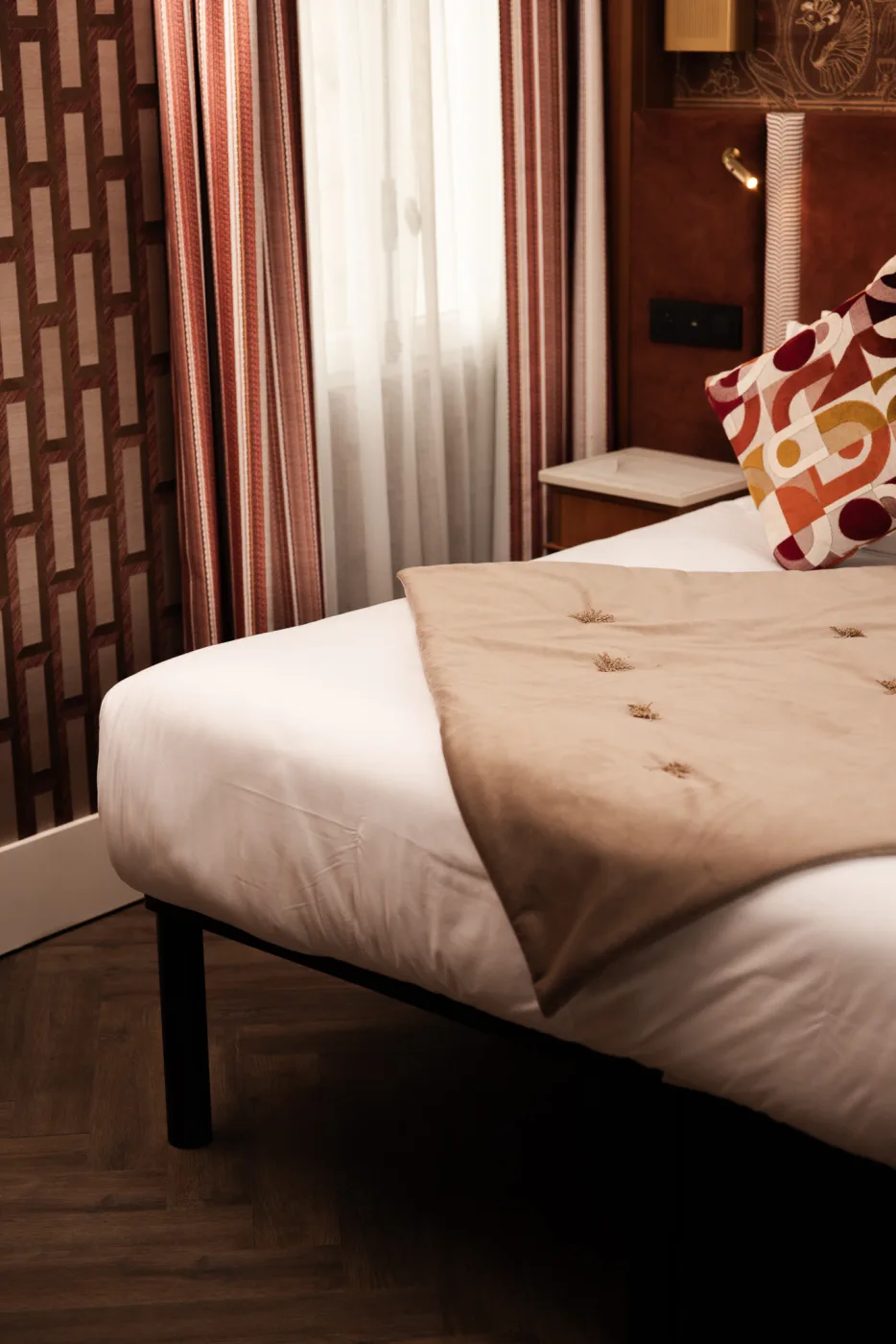 Détail chambre - literie premium et coussins, hôtel boutique Paris 18